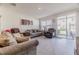 Bright living room with sliding doors leading to a patio at 54 Bella Oaks Dr, Port Orange, FL 32129