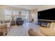 Spacious living area featuring a fireplace and large TV at 54 Bella Oaks Dr, Port Orange, FL 32129