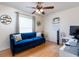 Home office with a blue sofa, desk, and wood floors at 652 Mountain Way Ave, Deltona, FL 32738