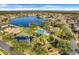 Aerial view of community, including pool, lake, tennis court at 826 Seneca Trl, St Cloud, FL 34772