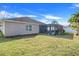 Spacious backyard with covered patio and green lawn at 826 Seneca Trl, St Cloud, FL 34772