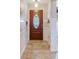 Clean entryway with wood door and tile flooring at 826 Seneca Trl, St Cloud, FL 34772