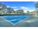 Community tennis court with blue surface at 826 Seneca Trl, St Cloud, FL 34772