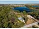 Lakefront property with a house, dock, and surrounding trees, seen from above at 9229 Lake Hickory Nut Dr, Winter Garden, FL 34787