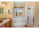 Bathroom with soaking tub, shower, and double vanity at 9229 Lake Hickory Nut Dr, Winter Garden, FL 34787