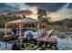 Covered boat lift with two boats and lights at sunset at 9229 Lake Hickory Nut Dr, Winter Garden, FL 34787