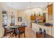 Bright dining area with a glass table and wicker chairs, adjacent to the kitchen at 9229 Lake Hickory Nut Dr, Winter Garden, FL 34787