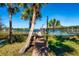 Wooden dock leading to a covered boathouse on a lake at 9229 Lake Hickory Nut Dr, Winter Garden, FL 34787