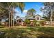 Single story home with metal roof, stone accents, and lush landscaping at 9229 Lake Hickory Nut Dr, Winter Garden, FL 34787