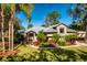 Single-story home with metal roof, stone accents, and lush landscaping at 9229 Lake Hickory Nut Dr, Winter Garden, FL 34787