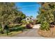 Single-story home with metal roof, landscaping, and a paved driveway at 9229 Lake Hickory Nut Dr, Winter Garden, FL 34787