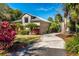 Single-story house with metal roof, stone accents, and tropical landscaping at 9229 Lake Hickory Nut Dr, Winter Garden, FL 34787