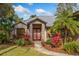 Front entrance of home with red double doors and stone accents at 9229 Lake Hickory Nut Dr, Winter Garden, FL 34787