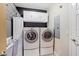 Laundry room with washer, dryer, and overhead cabinets at 9229 Lake Hickory Nut Dr, Winter Garden, FL 34787