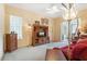 Living room with a red sofa, wooden entertainment center, and access to other rooms at 9229 Lake Hickory Nut Dr, Winter Garden, FL 34787