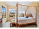 Spacious main bedroom with canopy bed and serene lake views at 9229 Lake Hickory Nut Dr, Winter Garden, FL 34787