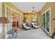 Relaxing sunroom with wicker furniture and French doors leading outdoors at 9229 Lake Hickory Nut Dr, Winter Garden, FL 34787