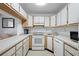 Galley-style kitchen with white appliances at 951 Courtyard Ln # 22, Orlando, FL 32825