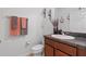 Cozy powder room featuring stylish fixtures, a decorative mirror, and neutral-toned towels at 958 Anna Pl, Davenport, FL 33837