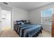 Bright bedroom featuring a comfortable bed, stylish decor, and ample natural light at 958 Anna Pl, Davenport, FL 33837