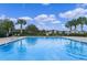 Relaxing community pool surrounded by lush landscaping and comfortable lounge chairs at 958 Anna Pl, Davenport, FL 33837