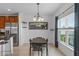 Bright dining area with a modern table set, stainless steel refrigerator, and a large window providing natural light at 958 Anna Pl, Davenport, FL 33837