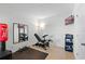 Well-lit exercise room with a punching bag, weight bench, and large mirror at 958 Anna Pl, Davenport, FL 33837