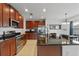 Well-equipped kitchen with stainless steel appliances, dark granite counters, and wood cabinets at 958 Anna Pl, Davenport, FL 33837