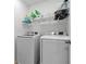 Functional laundry room with modern washer and dryer units and ample storage space at 958 Anna Pl, Davenport, FL 33837