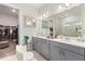 Modern bathroom with double vanity, large mirror, and a walk-in shower at 960 Ladera Ranch Rd, Kissimmee, FL 34759