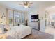 Spacious bedroom with a dresser and large windows at 960 Ladera Ranch Rd, Kissimmee, FL 34759