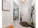 Inviting entryway with wood bench, coat rack, and view into dining room at 960 Ladera Ranch Rd, Poinciana, FL 34759