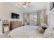 Bright main bedroom with a king-size bed, large windows, and a ceiling fan at 960 Ladera Ranch Rd, Kissimmee, FL 34759