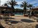 Resort-style pool with ample lounge chairs and palm trees for shade at 960 Ladera Ranch Rd, Kissimmee, FL 34759