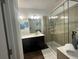 Bathroom with double vanity and shower at 3020 Cardillino Way, Kissimmee, FL 34741