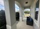 Covered porch with seating area, arched entryway, and view of the street at 3020 Cardillino Way, Kissimmee, FL 34741