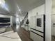 Modern kitchen with stainless steel appliances and white cabinetry at 3020 Cardillino Way, Kissimmee, FL 34741