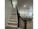 Modern staircase with LED lighting and dark wood railing at 3020 Cardillino Way, Kissimmee, FL 34741