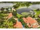 Aerial view of a lakeside community with a pool, lake views, and lush landscaping at 1000 Winderley Pl # 143, Maitland, FL 32751