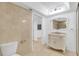 Bathroom featuring tile walls, marble sink, and walk in shower at 1000 Winderley Pl # 143, Maitland, FL 32751