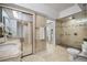 Bright bathroom featuring sink, mirror, walk-in shower, toilet and plants at 1000 Winderley Pl # 143, Maitland, FL 32751
