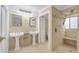 Elegant bathroom with double sinks, a walk-in shower, and tiled walls at 1000 Winderley Pl # 143, Maitland, FL 32751