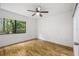 Bedroom with hardwood floors, ceiling fan and window overlooking greenery at 1000 Winderley Pl # 143, Maitland, FL 32751