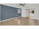 Comfortable bedroom with a large window, laminate floors, and a sliding glass door to the outside at 1000 Winderley Pl # 143, Maitland, FL 32751