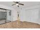 Bright bedroom with laminate floors, ceiling fan, and sliding door to the outside patio at 1000 Winderley Pl # 143, Maitland, FL 32751