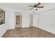Bright bedroom features wood-look floors, ceiling fan, ensuite bath, and neutral paint at 1000 Winderley Pl # 143, Maitland, FL 32751