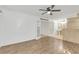 Spacious bedroom featuring hardwood floors, ceiling fan, and entrance to ensuite bathroom and closet at 1000 Winderley Pl # 143, Maitland, FL 32751