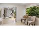 Cozy breakfast nook with seating for two and views of the lush greenery outside at 1000 Winderley Pl # 143, Maitland, FL 32751