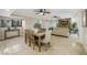 Dining area with travertine floors, a wooden table, and direct access to both the kitchen and living room at 1000 Winderley Pl # 143, Maitland, FL 32751