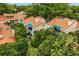 Charming condos featuring red tile roofs, blue awnings, and mature trees creating a serene neighborhood setting at 1000 Winderley Pl # 143, Maitland, FL 32751
